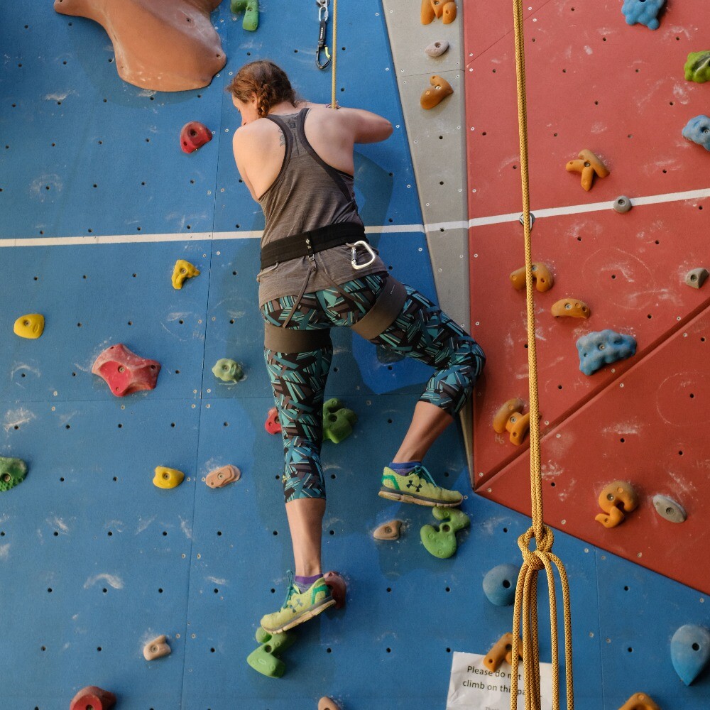 Adult climber enjoying the climbing wall at Evesham Leisure Centre, featuring fun experiences, courses, and recreational sessions.