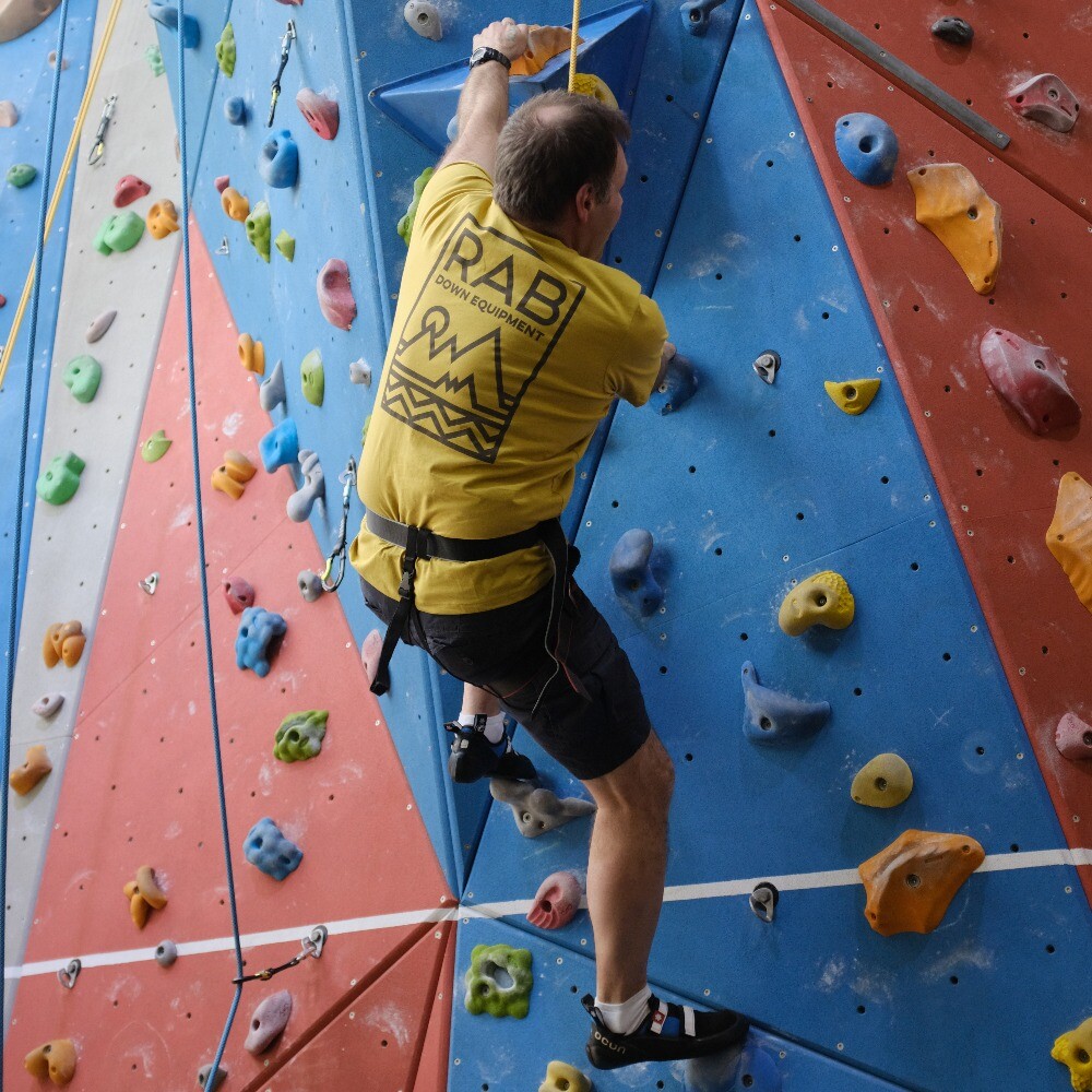 Adult climber enjoying the climbing wall at Evesham Leisure Centre, featuring fun experiences, courses, and recreational sessions.